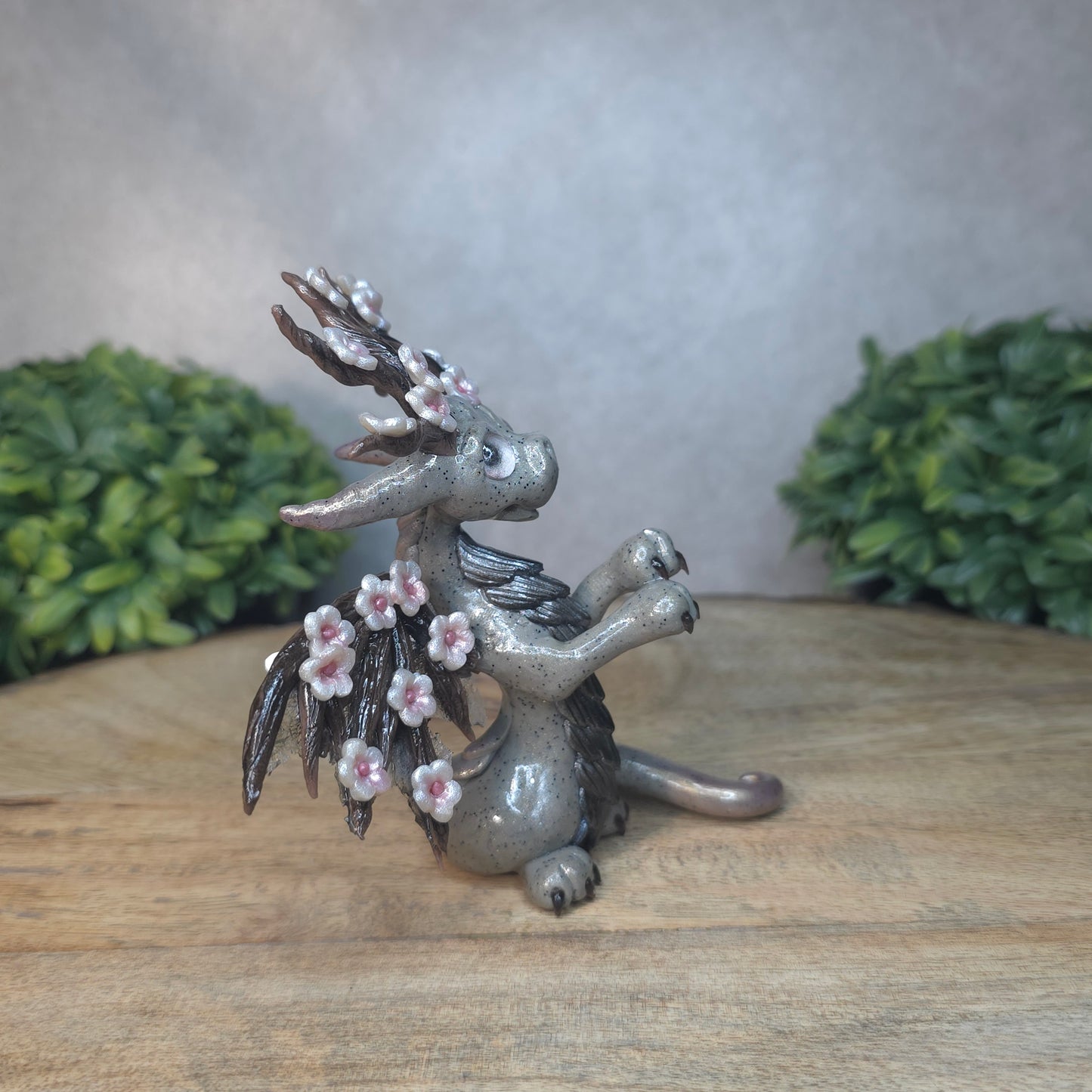 A gray colored dragon with cherry blossom accents