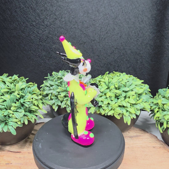 A video of a clown dragon on wood surface with greenery