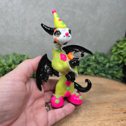 A clown dragon on wood surface with greenery