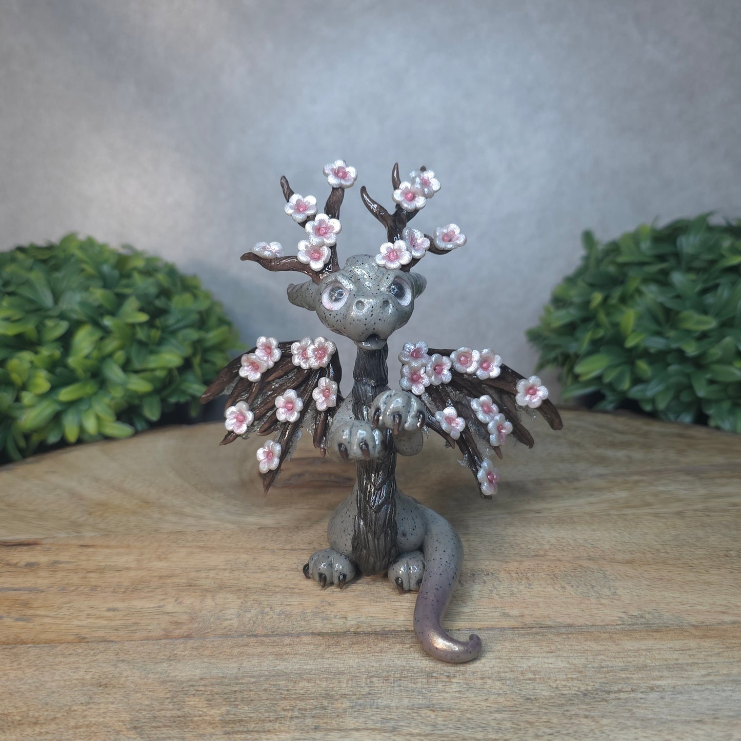 A gray colored dragon with cherry blossom accents