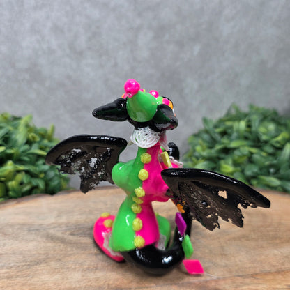 A clown dragon on wood surface with greenery