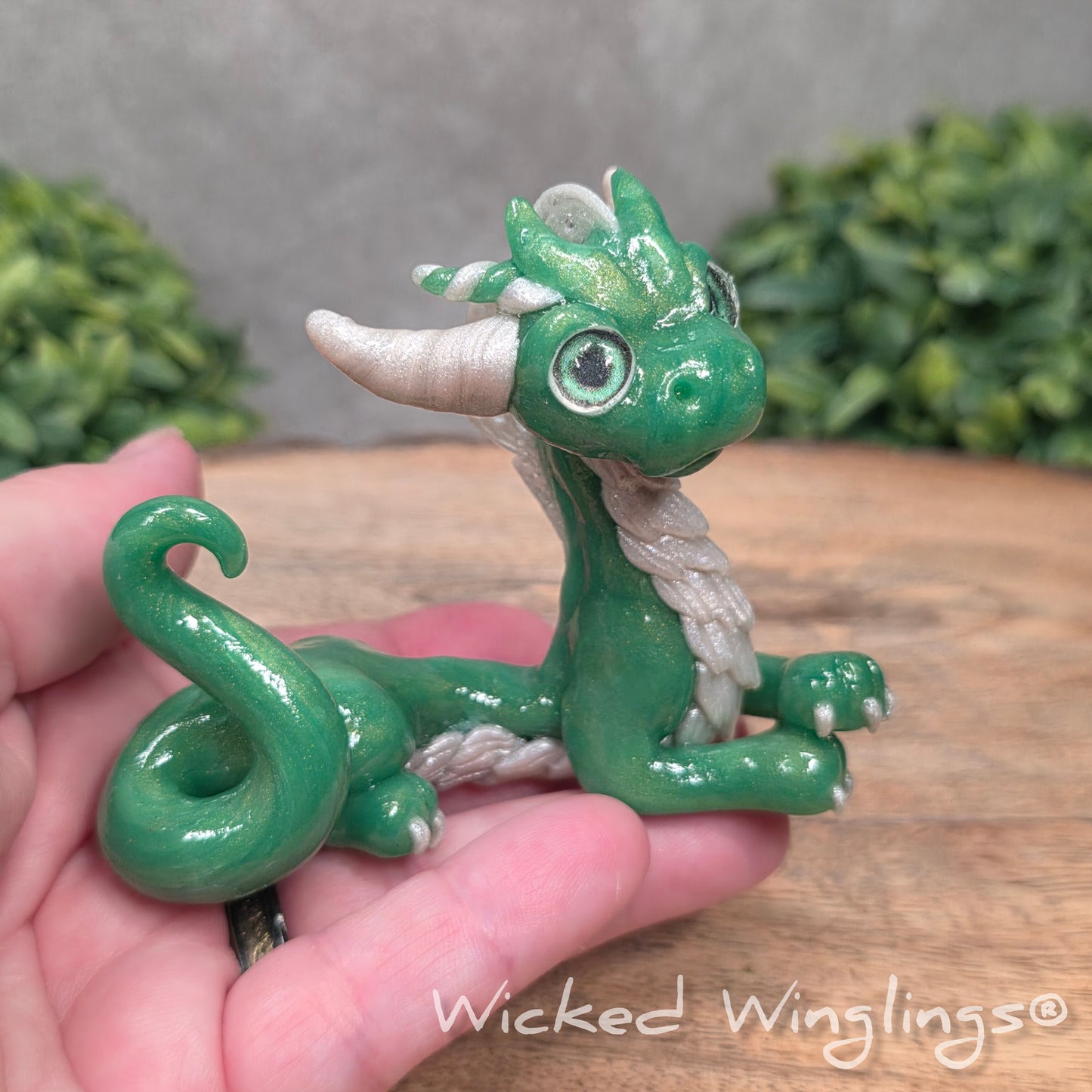 A hand holding a dragon sculpture