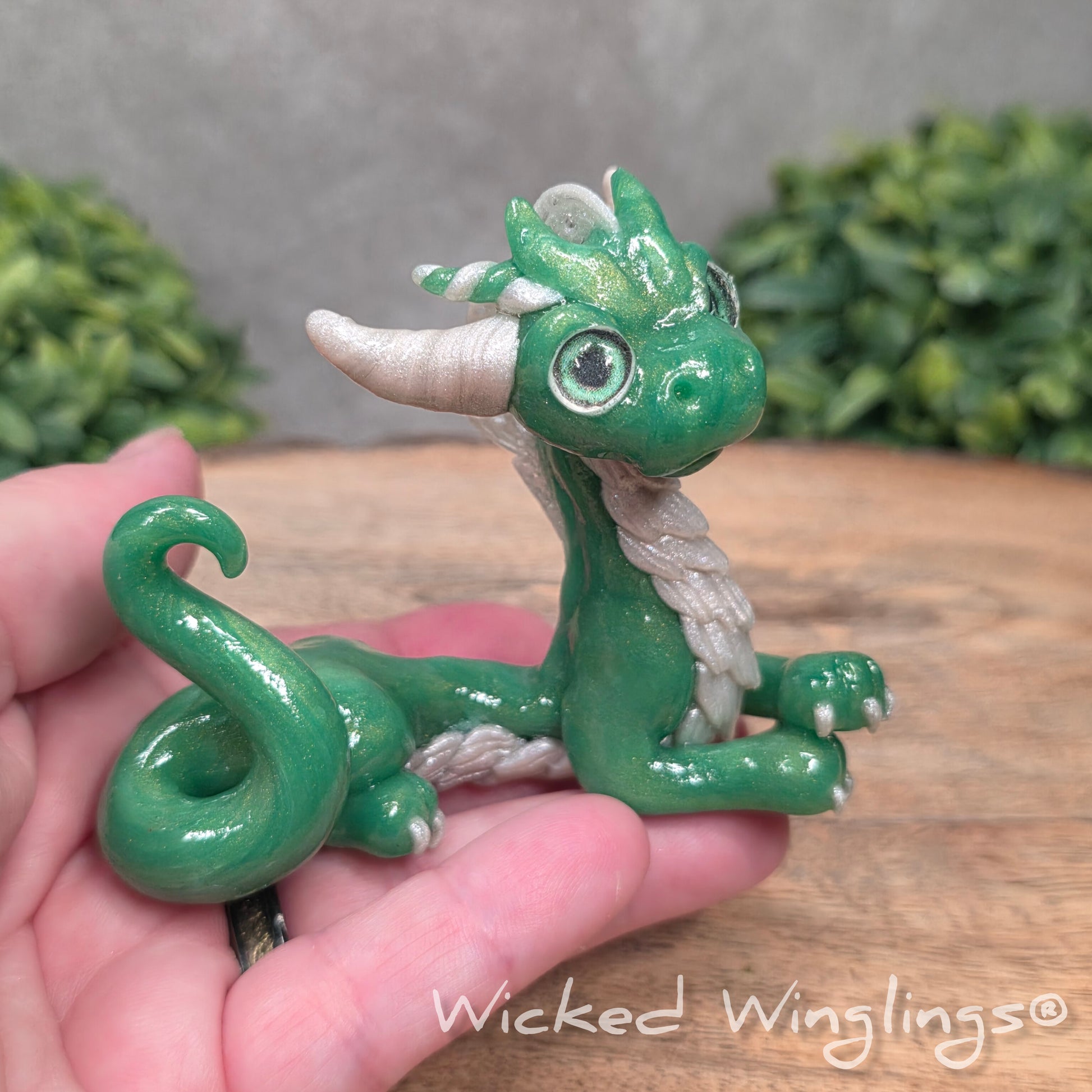 A hand holding a dragon sculpture
