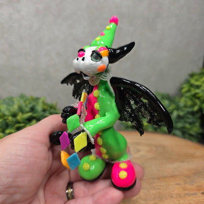 A clown dragon on wood surface with greenery