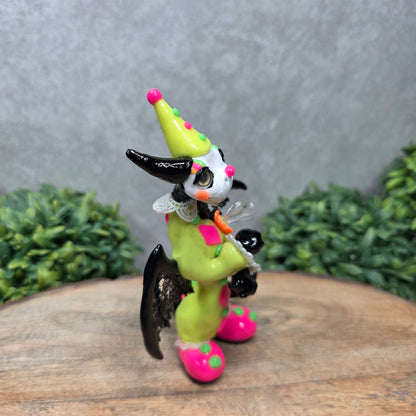 A clown dragon on wood surface with greenery