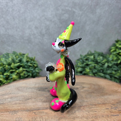 A clown dragon on wood surface with greenery