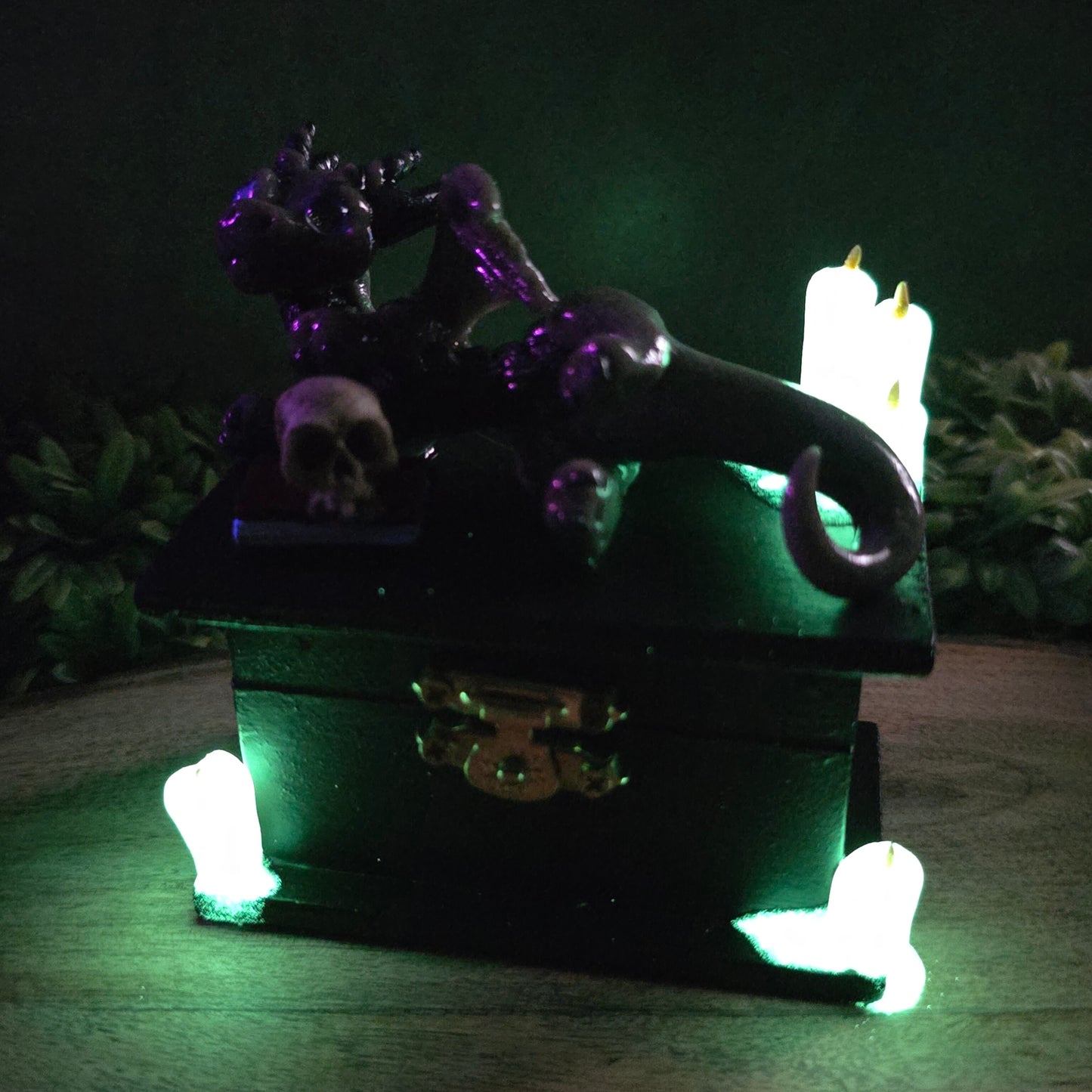 Clay candles glowing in dark with a dragon on box