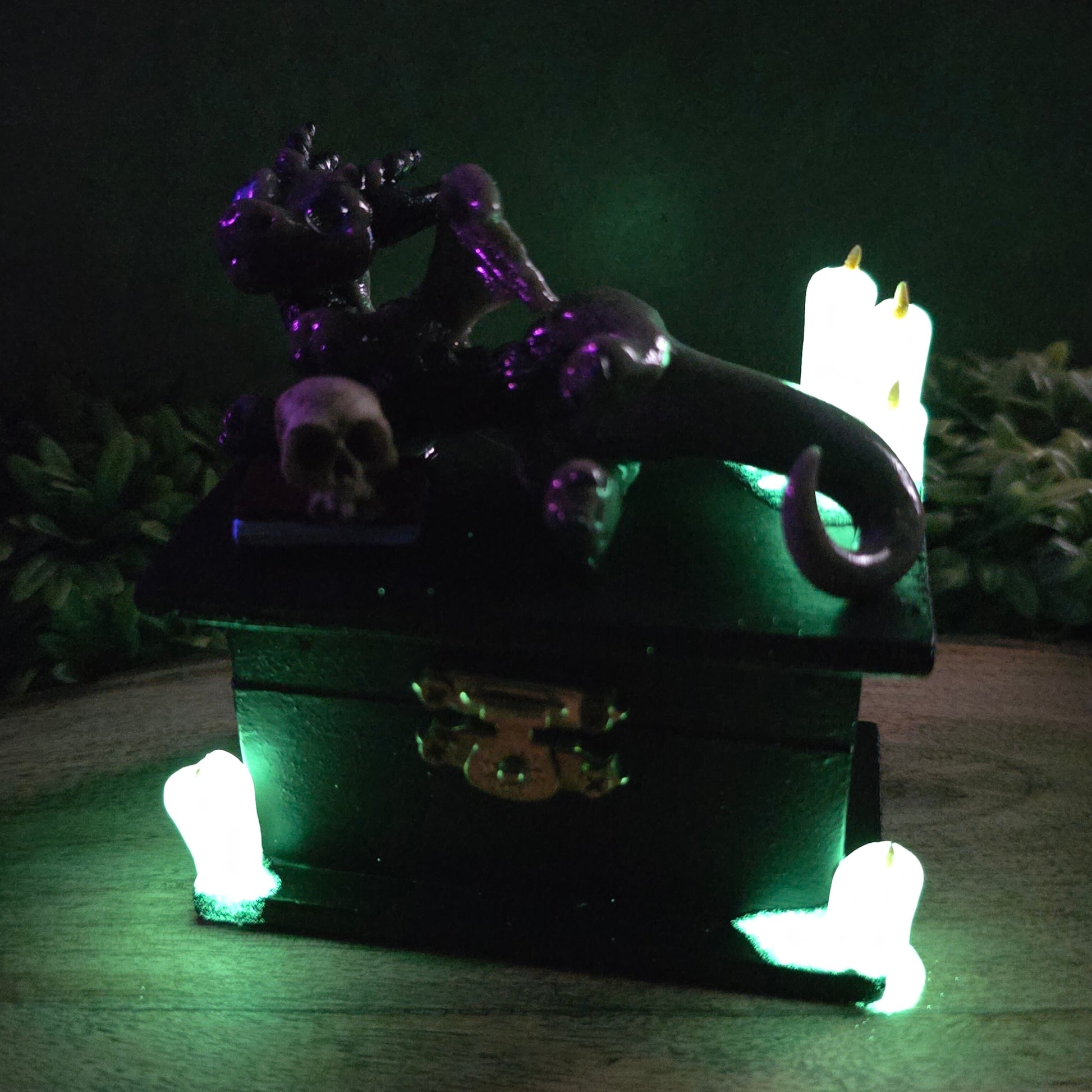 Clay candles glowing in dark with a dragon on box