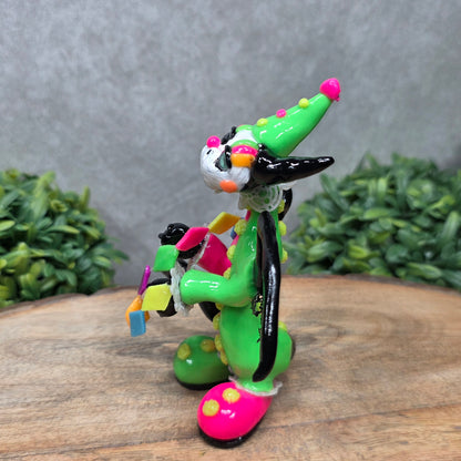 A clown dragon on wood surface with greenery