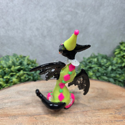 A clown dragon on wood surface with greenery