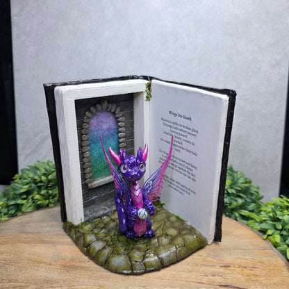 Book nook with fairy dragon on a wood surface with greenery