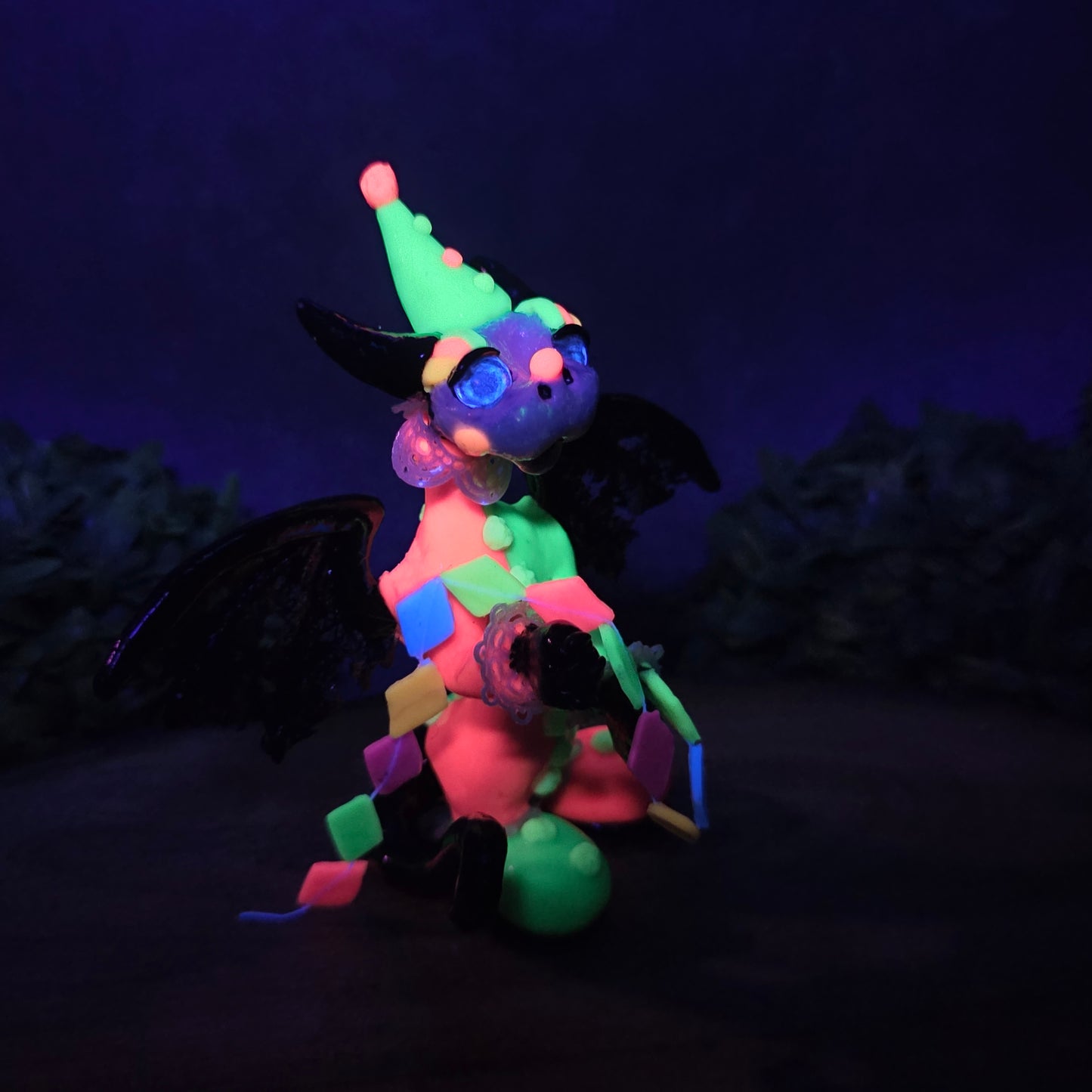A clown dragon on wood surface with greenery